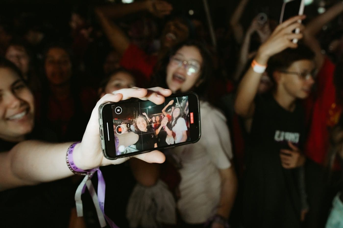 A guest holding up a phone at an event with a photo on the screen